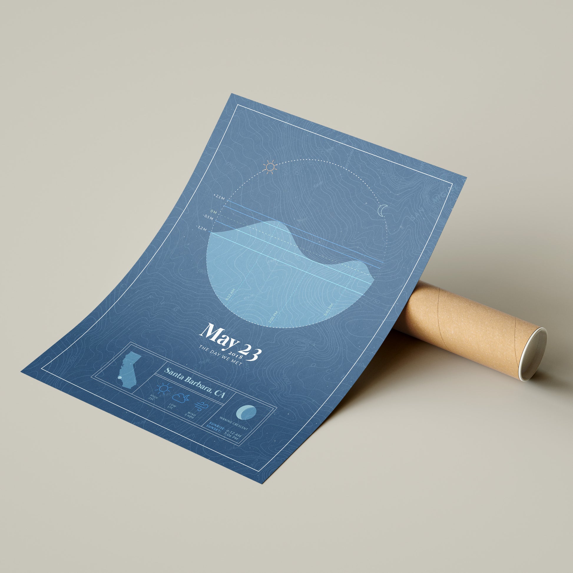 the personalized tide map poster by salt atlas in the vintage cobalt blue color option next to the eco friendly cardboard packaging. These are custom posters showing the tide, weather, and moon phase for a special day, like an anniversary or birthday.